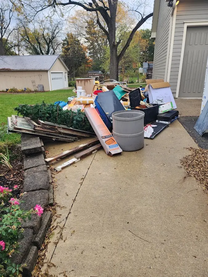 Dumpster being loaded with debris for Commercial Dumpster Rental in North Bend